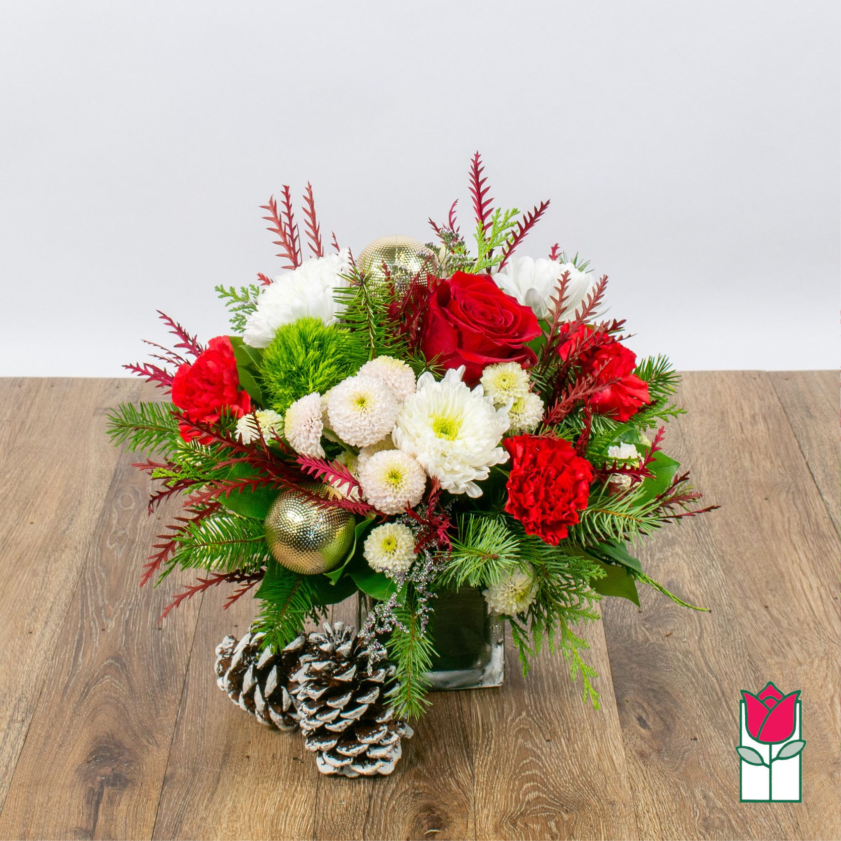 Beretania's Christmas Elegance Bouquet (Seasonal Flowers Vary) - Introducing the enchanting Christmas Floral Collection at Beretania Florist, where the spirit of the season blossoms with every petal. Our commitment to quality shines through in every handcrafted arrangement, making each piece a masterpiece of fresh premium flowers and a variety of fragrant Christmas greens.  Embrace the magic of the holidays with our exquisite Christmas floral items. While the final creation may showcase a unique selection of fresh blooms and foliage, the end result is guaranteed to resemble the stunning product photos on our website. Each arrangement is thoughtfully designed to capture the essence of Christmas, whether you prefer the traditional reds and greens or a more modern interpretation of the season.  At Beretania Florist, we understand the importance of timely delivery during the holiday rush. That's why we offer fast and reliable delivery services in the Honolulu area, ensuring your festive arrangements arrive at their destination in perfect condition. Additionally, for those who prefer a more hands-on approach, we offer free local pickup for your convenience.  Experience the joy of Christmas with the elegance and charm of our Christmas Floral Collection. Trust Beretania Florist to provide you with the freshest, most captivating floral arrangements, and make this holiday season truly unforgettable. Place your order today and let us help you celebrate the magic of Christmas in style.