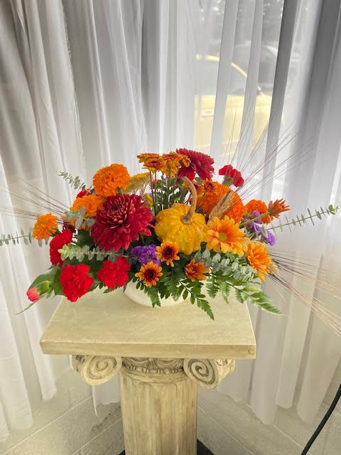Family Ties (one-sided design) - Chrysanthemums, carnations, wheat, gourds, and more are gathered in a low container to make a lovely feast for the eyes for your Thanksgiving.  