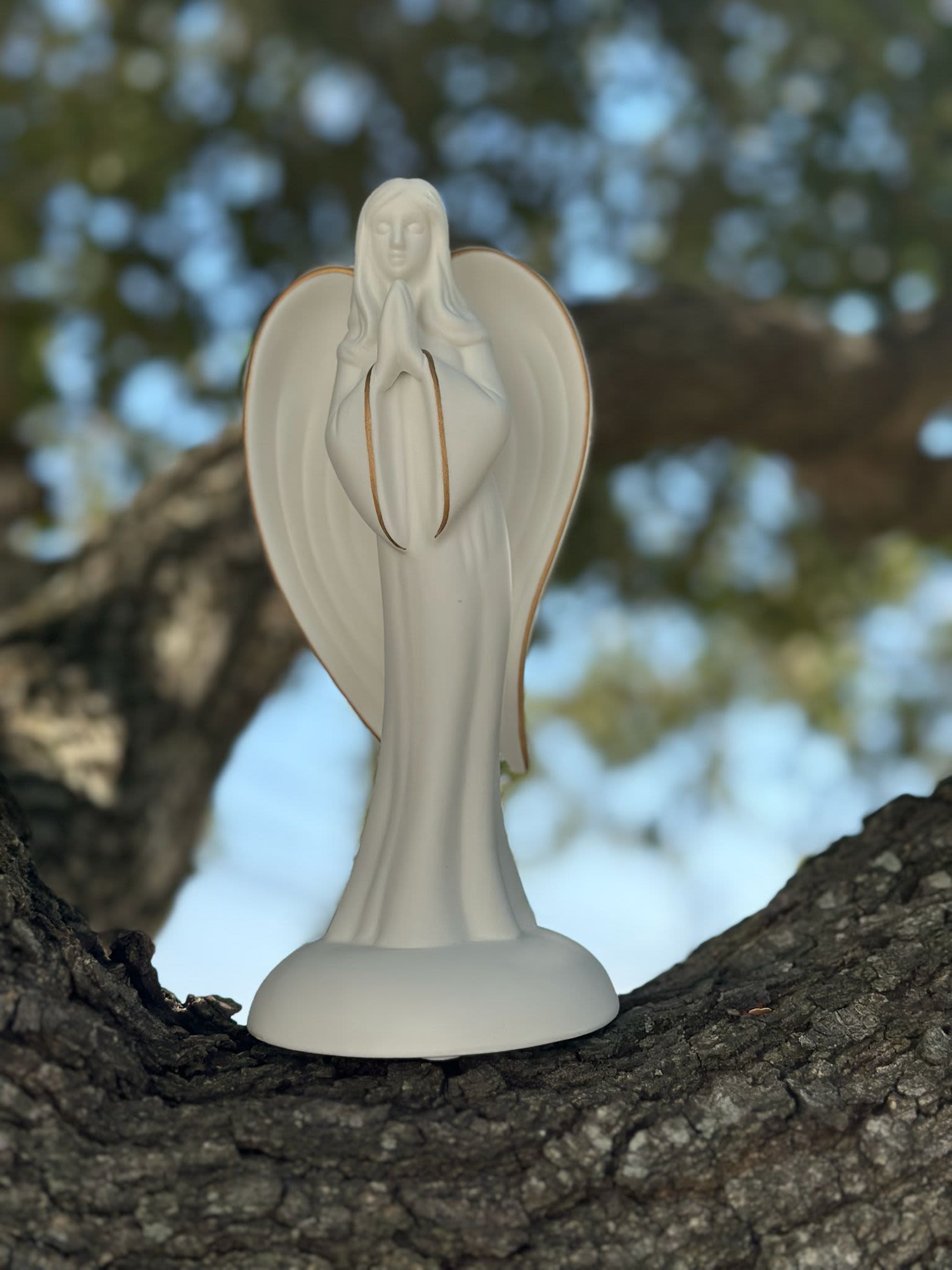 Ceramic Praying Angel Keepsake - ring comfort and peace to any sympathy or funeral arrangement with our Ceramic Praying Angel Keepsake. Crafted from smooth white ceramic with soft gold accents, this serene angel symbolizes faith, protection, and everlasting love. A touching addition to casket sprays, standing easels, or table arrangements, and a beautiful keepsake for the family to treasure long after the service. Free same-day delivery available across Houston and surrounding areas.  #SympathyFlowers #FuneralArrangements #MemorialAngel #HoustonFlorist #CeramicKeepsake #FloralConcepts #FaithAndComfort #FuneralFlowersHouston #SympathyGifts