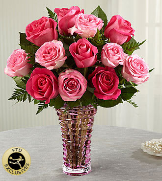 The FTD Royal Treatment Rose Bouquet - This sumptuous bouquet of roses in delightful shades of pink, are simply spectacular, arranged in a heavy, pink glass contemporary vase.