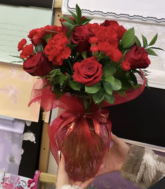 You're In My Heart - Let your love bloom with this beautiful You're In My Heart flower bouquet. This all red flower arrangement is hand-arranged by a local florist near you with classic red roses, along with red carnations. All the red flowers make this gift a wonderful way of letting someone in your life know they are important to you and you appreciate all the love they give you. The red roses and carnations are delivered in a clear glass vase with a red ribbon tied around the center. Measures 17"H by 15"L   Includes:  • Red Roses  • Red Carnations • Red Mini Carnations  • Decorative Red Ribbon • Florist Delivered  • Clear Glass Vase