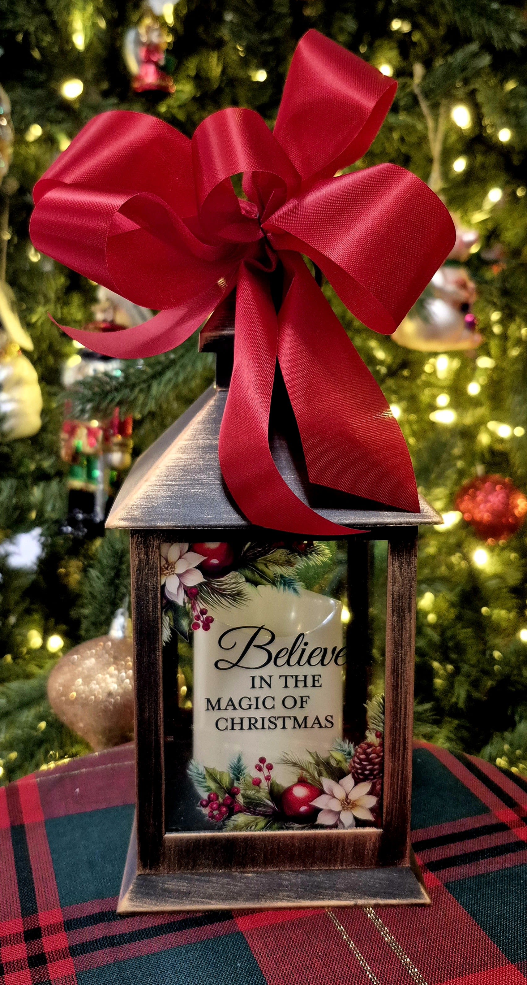 Believe in the Magic of Christmas Lighted Lantern - Message on the lighted lantern reads &quot;Believe in the Magic Of Christmas&quot;. Great gift for a child or adult, what a wonderful gift to receive and be able to use for many years to come.  9&quot; H  Comes with 3 triple A batteries and a bow. 