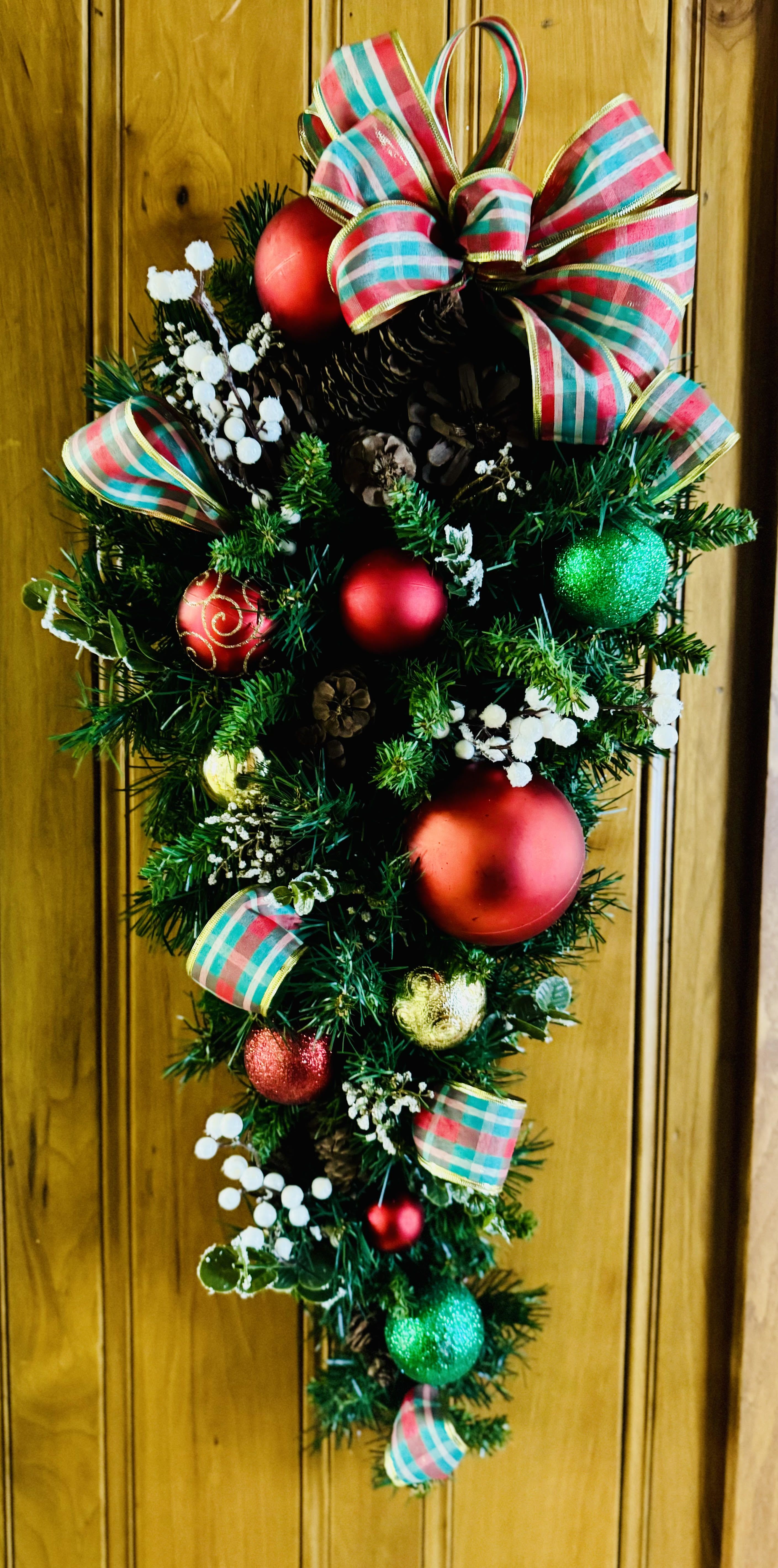 Christmas Red Poinsettia Tear Drop Swag - This beautiful Silk Christmas Tear Drop Swag is adorned with gold, red and green christmas bulbs, white berries and a red, green and gold plaid bow. Great gift or addition to your Christmas decor. Perfect for hanging on a door or wall in your home.  32&quot; Long 