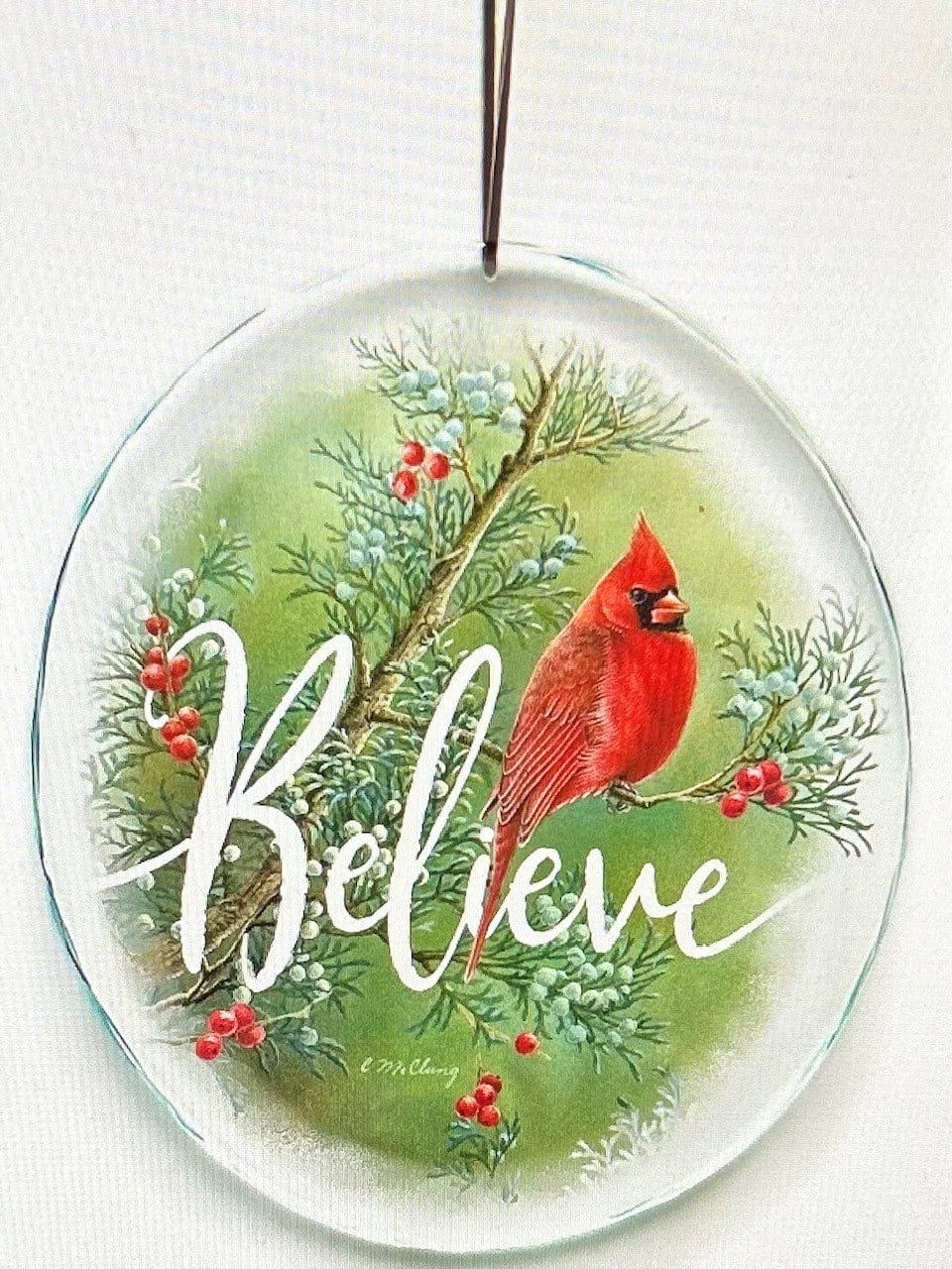 Believe Cardinal Stained Glass Suncatcher - Beveled-cut glass suncatchers feature images from your favorite Wild Wings artists. Includes 10&quot; leather cord for hanging and black fabric lined box for storage. Printed with fade-resistant inks. Made exclusively by Wild Wings. Designed and printed in the USA. Size, 8&quot;H x 7&quot;W, weighs 18oz.  Each Stained Glass comes with a small easel stand for presentation. 