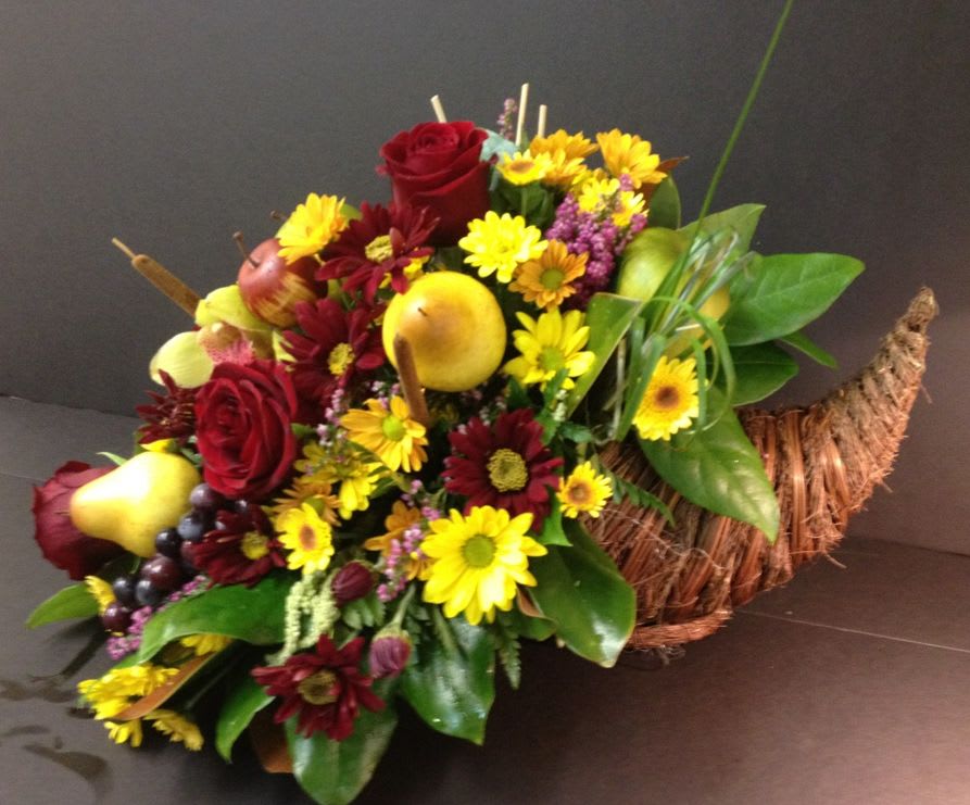 Bountiful Floral Cornucopia - Exquisite rose blooms, chrysanthemums, premium fills and greens pour out of this rustic horn of plenty - ready to adorn and finish off any Thanksgiving feast....
