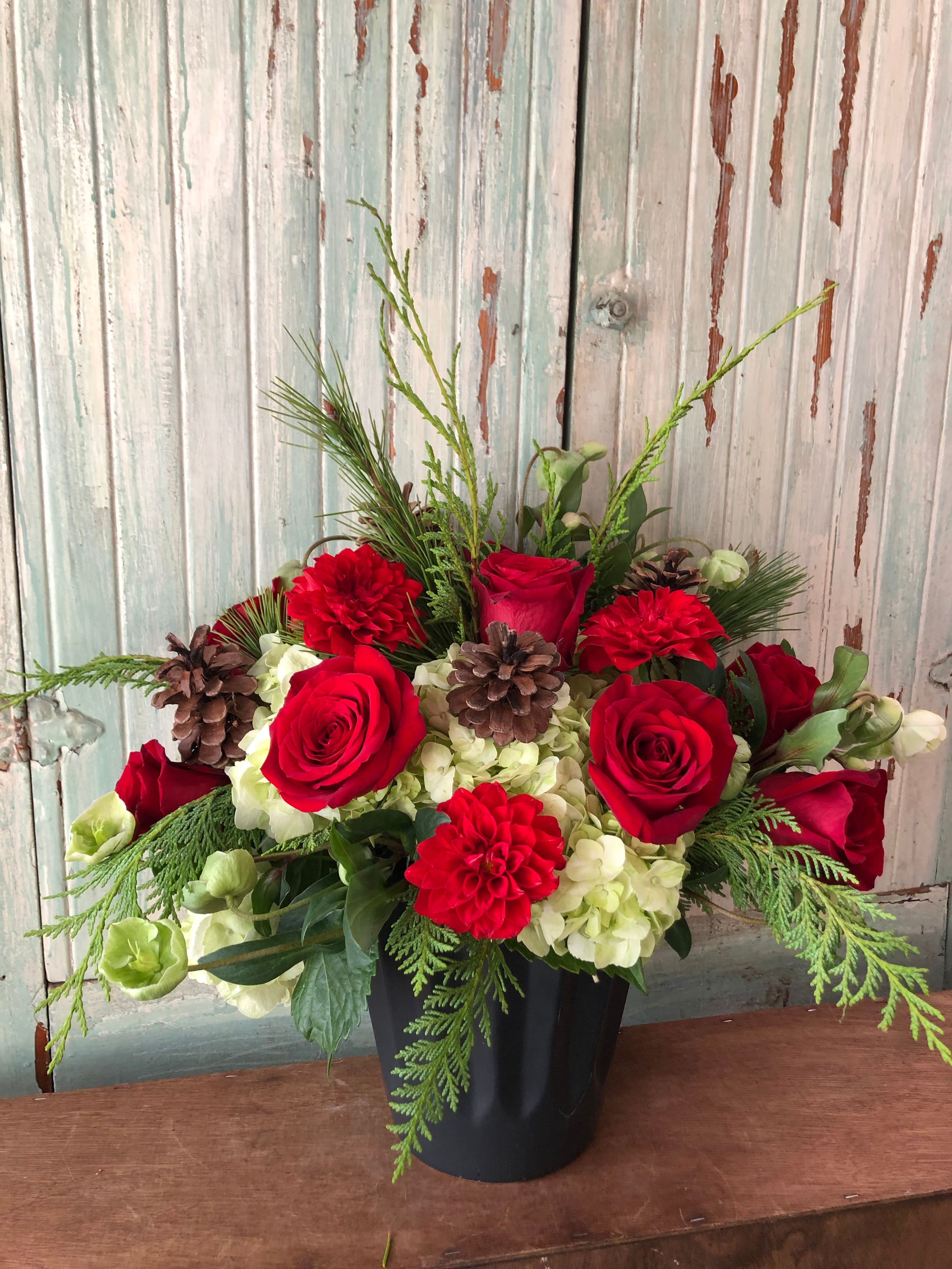 Festive Mix - Festive  mix of green hydrangea, red roses, dahlia, seasonal greenery in ribbed mat-black ceramic pot. Due to covid related shortages we may not be able to match the arrangement exactly.  Containers or flowers may substituted at designers discretion. Thank you for your understanding.