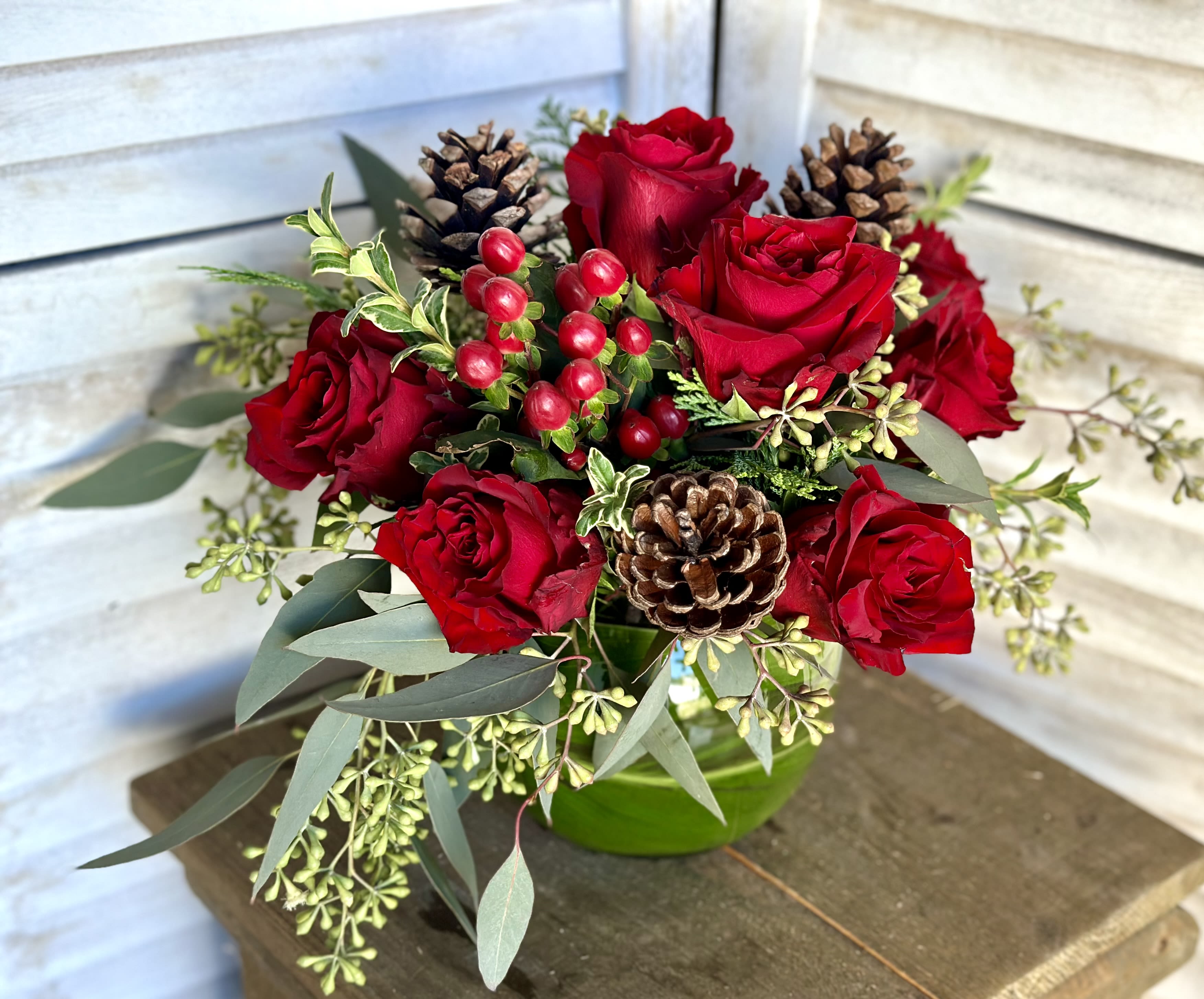 Holiday Bowl - 6&quot; blass bowl with ti leaf lining filled wiht the seasons finest greenery, roses, hypercum &amp; pinecones.