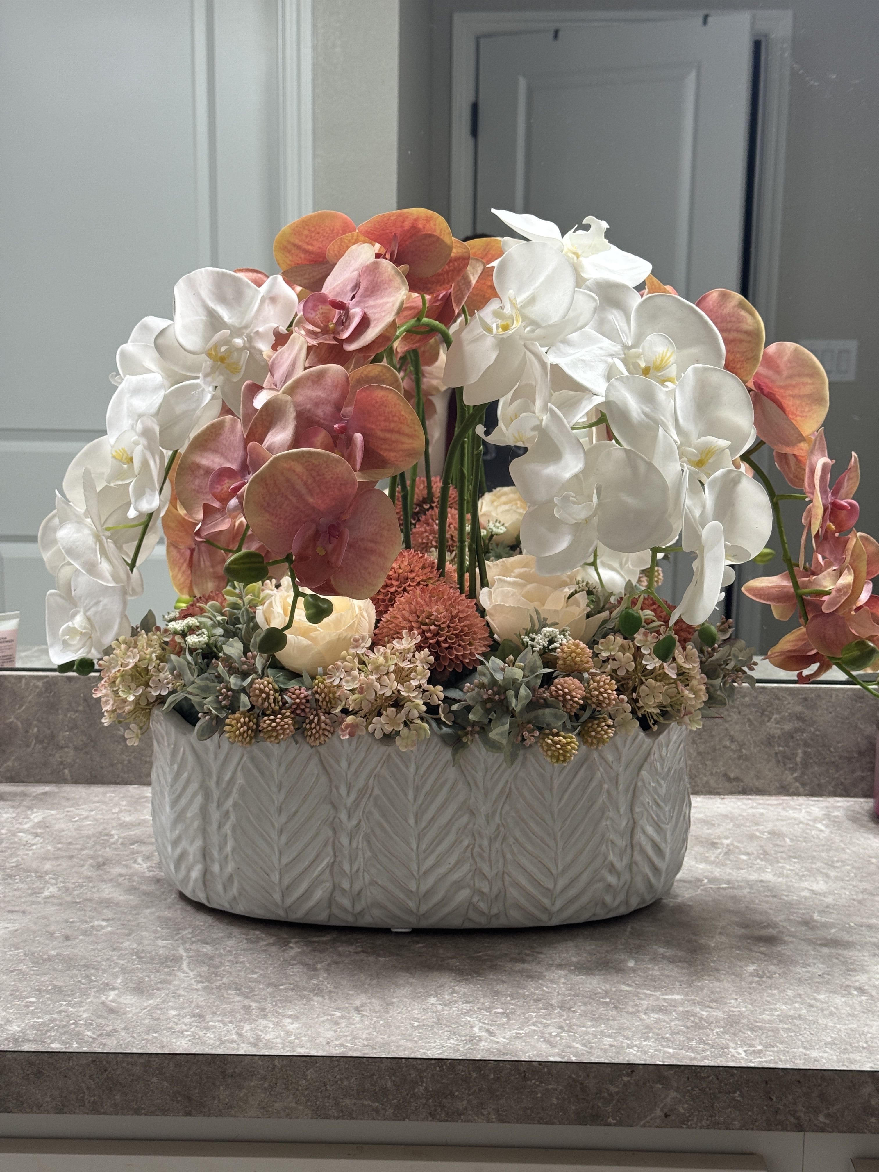 Silk Forever Orchid Luxe  - Crafted with premium silk, this oversized orchid arrangement is set in a ceramic vase . Ideal for hotels, receptions, and elegant home décor.   Measurements approximate 24 W by 22H.