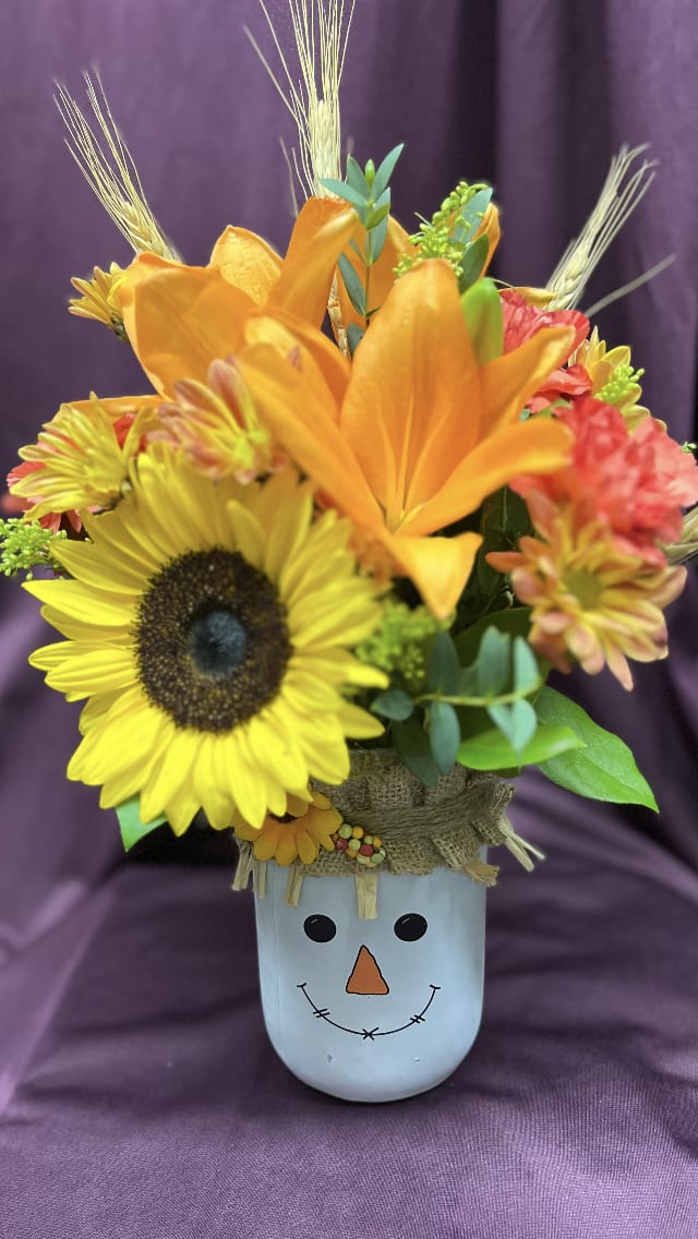 Fall Scarecrow Mason Jar - Delight anyone who loves the Fall Season with this sweet and fun keepsake scarecrow mason jar filled with designer's choice seasonal flowers.
