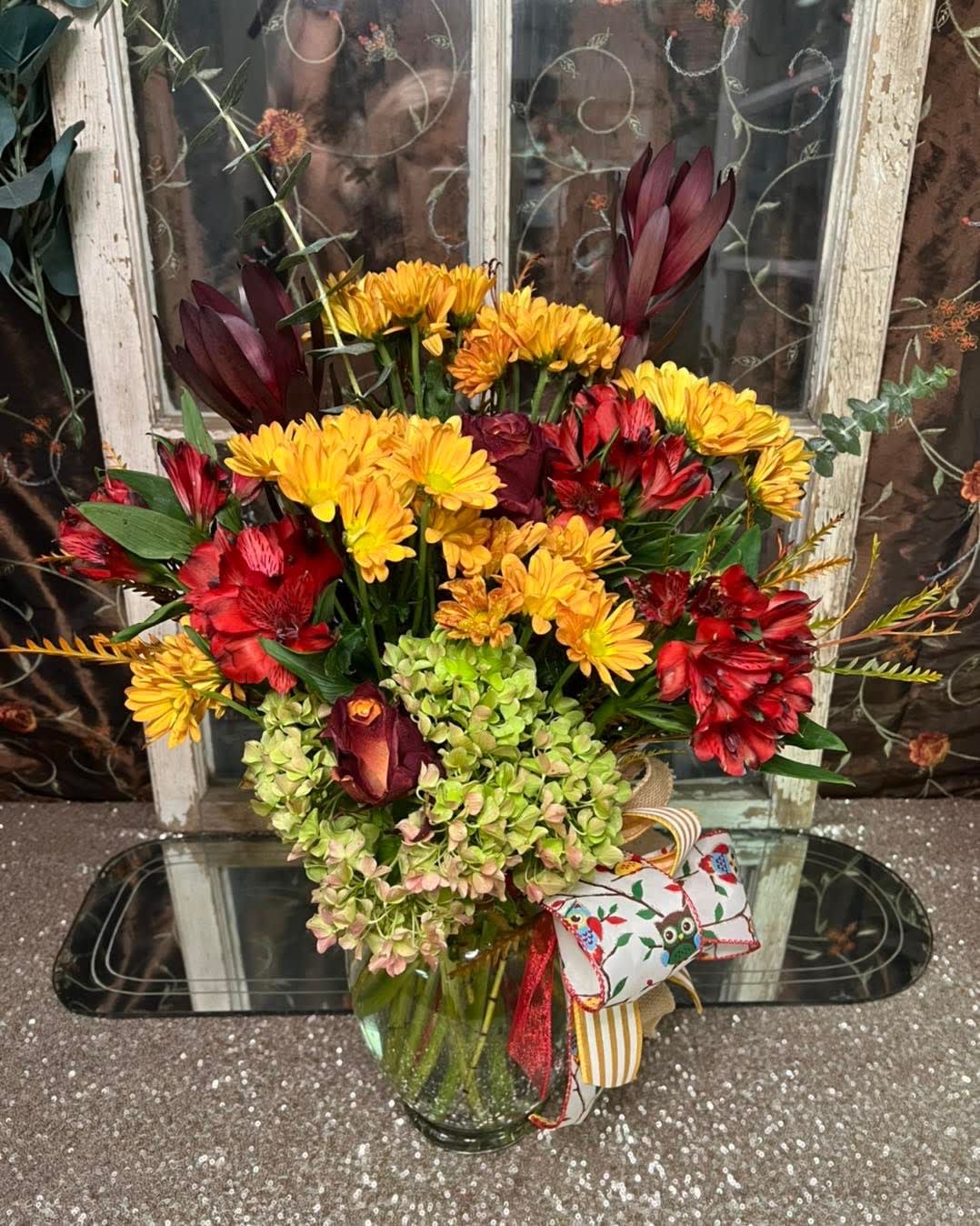 Autumn's Bloom Bouquet -  We will hand select the nicest fall blooms for your special arrangement. A custom selection of the season's best, assorted rich, vibrant florals will fill a glass vase for a gift that will turn heads!  Standard is shown, Deluxe and Premium sizes will reflect a grander gesture.