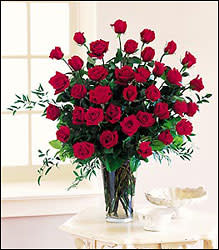 Three Dozen Long Stem Red Roses -  Nothing says &quot;I love you&quot; like a dramatic bouquet of ravishing long stemmed red roses, enveloped in a lush backdrop of fresh lemon leaves. Delivered in a classically graceful vase, it's an unforgettable romantic gesture. A truly breathtaking tribute to your love, this romantic arrangement bursts with a 3-dozen long stem red roses, nestled among delicate greens. The perfect I love you.  