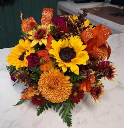 Colorful Cornucopia  - Celebrate the beauty of the season with this stunning arrangement designed in a charming ceramic cornucopia. Bursting with rich fall blooms, rustic textures, and warm autumn tones, this piece overflows with the spirit of gratitude and gathering. Seasonal roses, mums, daisies, and accenting foliage spill gracefully from the horn of plenty, creating a lush, welcoming display perfect for Thanksgiving tables, cozy homes, or as a heartfelt gift just because! A timeless symbol of bounty and warmth — this cornucopia brings the magic of fall straight to your space.