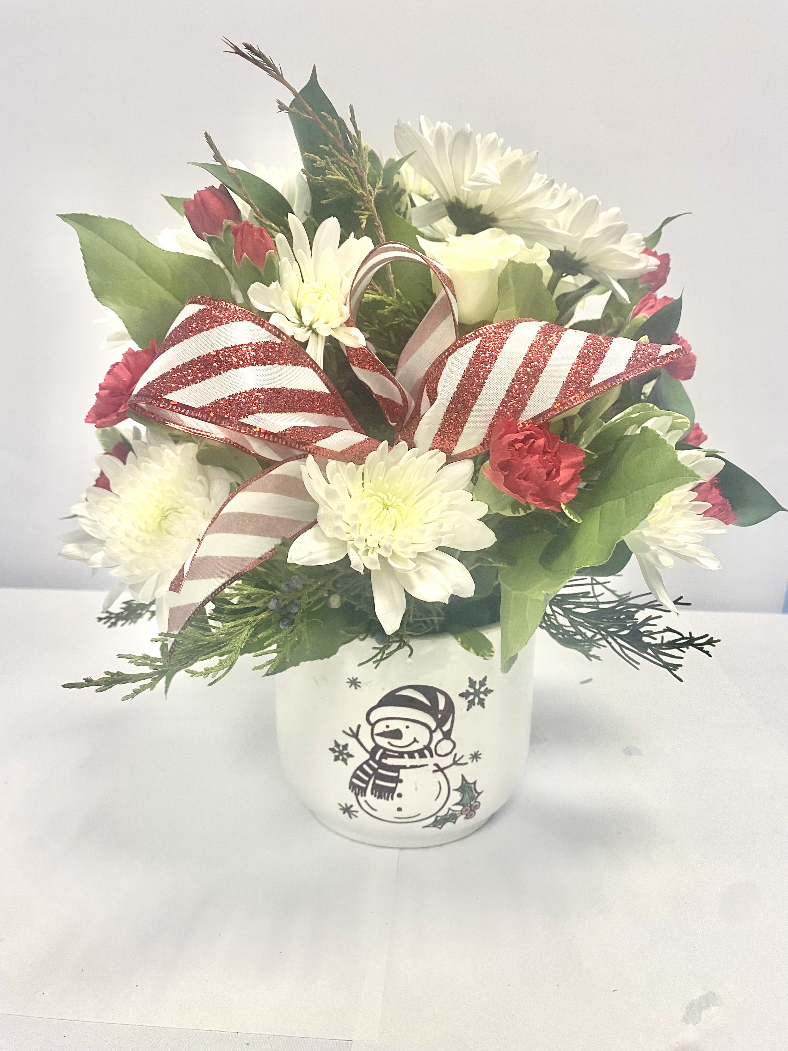Frosty - This cute Frosty container full of fresh flowers will surely warm the hearts of the person you send this to. 