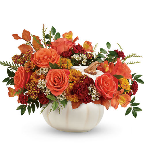  white ceramic pumpkin,  - Orange roses, orange alstroemeria, miniature maroon carnations, and yellow viking daisy spray chrysanthemums are accented with white waxflower, red cottage yarrow, huckleberry, grevillea, brown copper beech and yellow preserved oak leaves