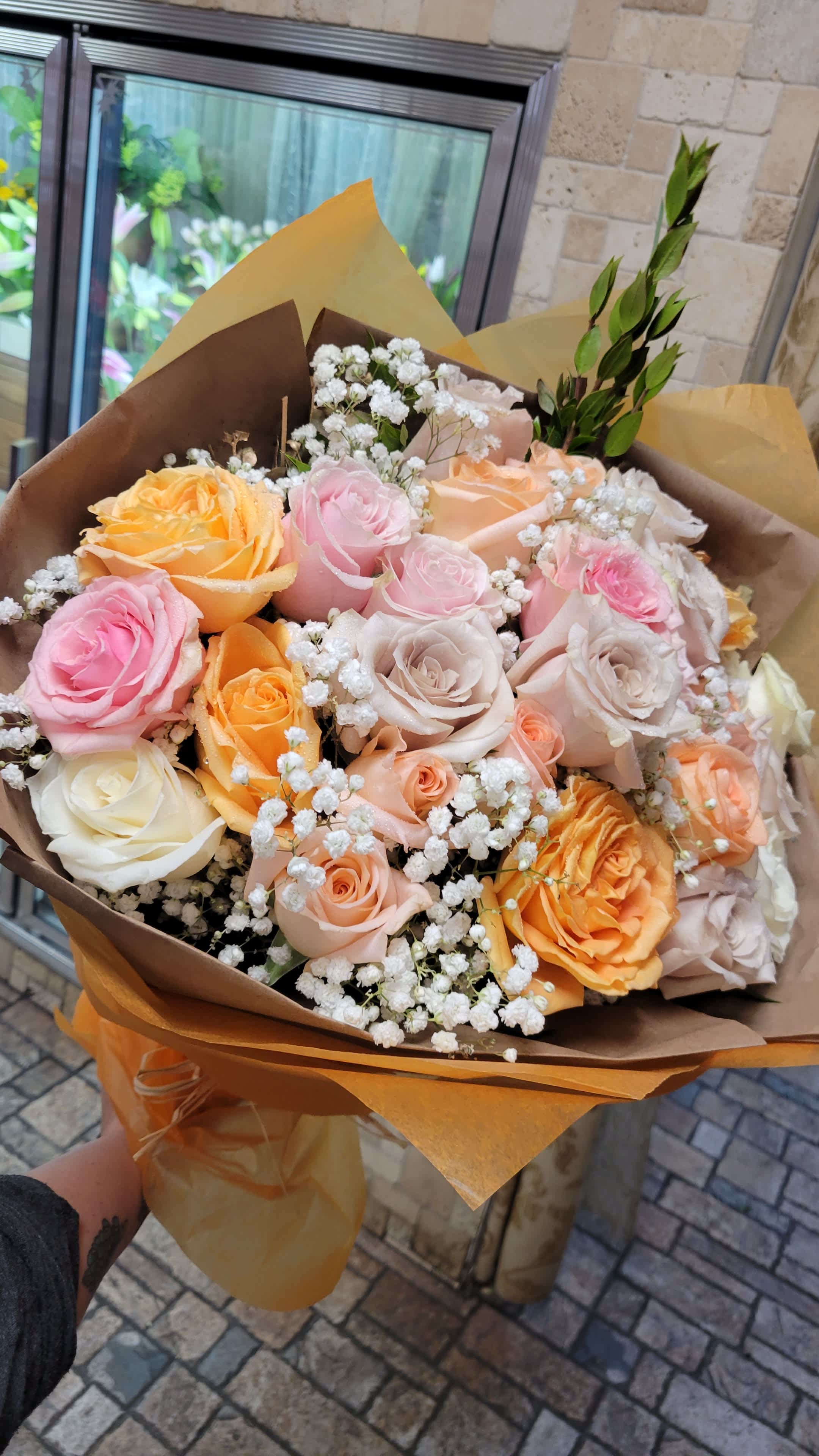 Peachy Keen - A deluxe wrapped bouquet with 2 dozen assorted pastel roses including peach, creams, and soft pinks mixed to perfection with babies breath accent throughout. 24 roses in total, wrapped in our premium paper. *Wrap color will vary. 
