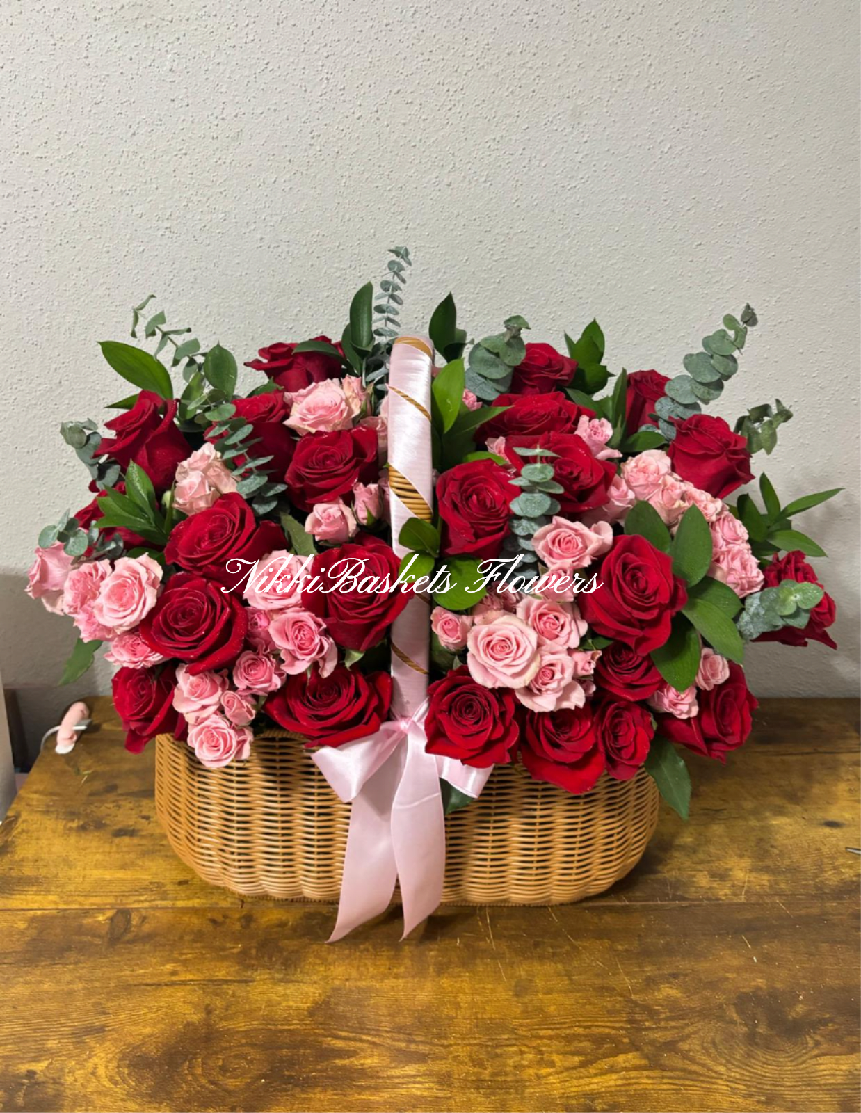 Luxury Red &amp; Pink Rose Basket - This stunning Luxury Rose Basket is designed to impress at first sight. Overflowing with premium red roses, soft pink roses, spray roses, lush greenery, and touches of eucalyptus, it creates a romantic and elegant statement piece perfect for anniversaries, birthdays, proposals, Valentine’s Day, or any special celebration. Arranged in a beautiful hand-woven wicker basket and finished with a soft satin bow, this design brings a luxurious floral touch to any space. Colors and rose varieties may vary depending on seasonal availability.
