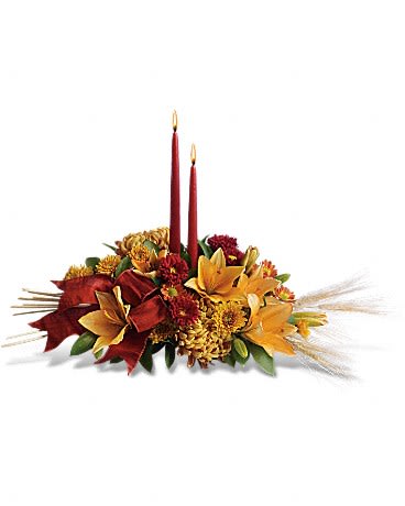 Golden Glow Centerpiece by Teleflora - Make Thanksgiving all the more special by bringing a graceful glow to the table. Everyone will be filled with gratitude in the presence of such beauty (colors may vary based on availability) This is a small centerpiece (less than 10&quot; around) 