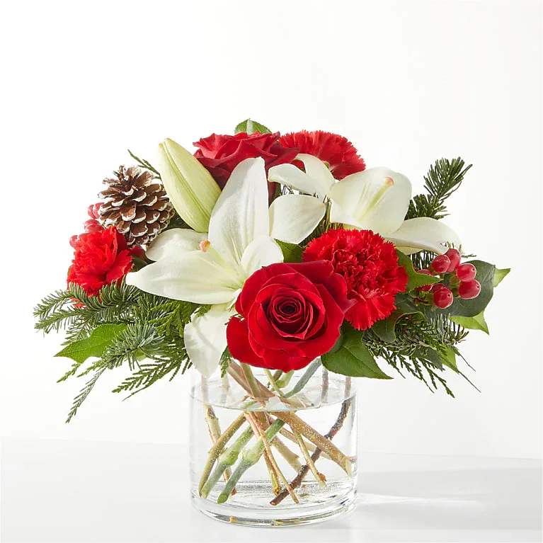 Eckert Florist's FTD Oh So Jolly Bouquet - This bouquet is sure to shimmer as bright as the holiday lights with lush carnations, roses, and lilies bursting from the vase. *Flowers and greens varieties may vary