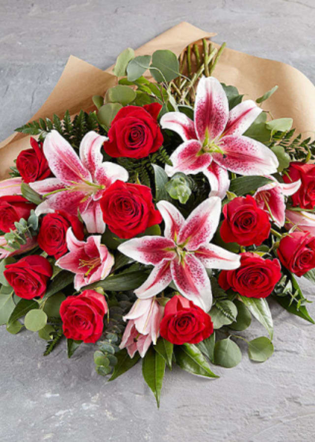 I Will Always Love You Wrapped Boquet - I Will Always Love You Wrapped Boquet features roses, star gazer lillies, filler flowers and lush greens.  Our loose bunches are designed with fresh flowers, individually created by our designers, wrapped, and finished with a lovely bow. These bouquets will vary daily based off of the best seasonal selection.  Our loose bunches do NOT include vases. Paper and bow color will vary.