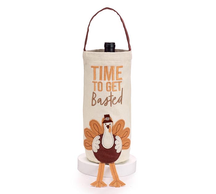 &quot;Time To Get Basted&quot; Bottle Bag - Cream Thanksgiving bottle bag with a brown handle. There is the message &quot;Time to get basted&quot; embroidered on the bag with a turkey applique under with dangling legs.  14 1/2&quot;H X 4 1/2&quot;W X 4 1/2&quot;D, 19&quot;H including handle.