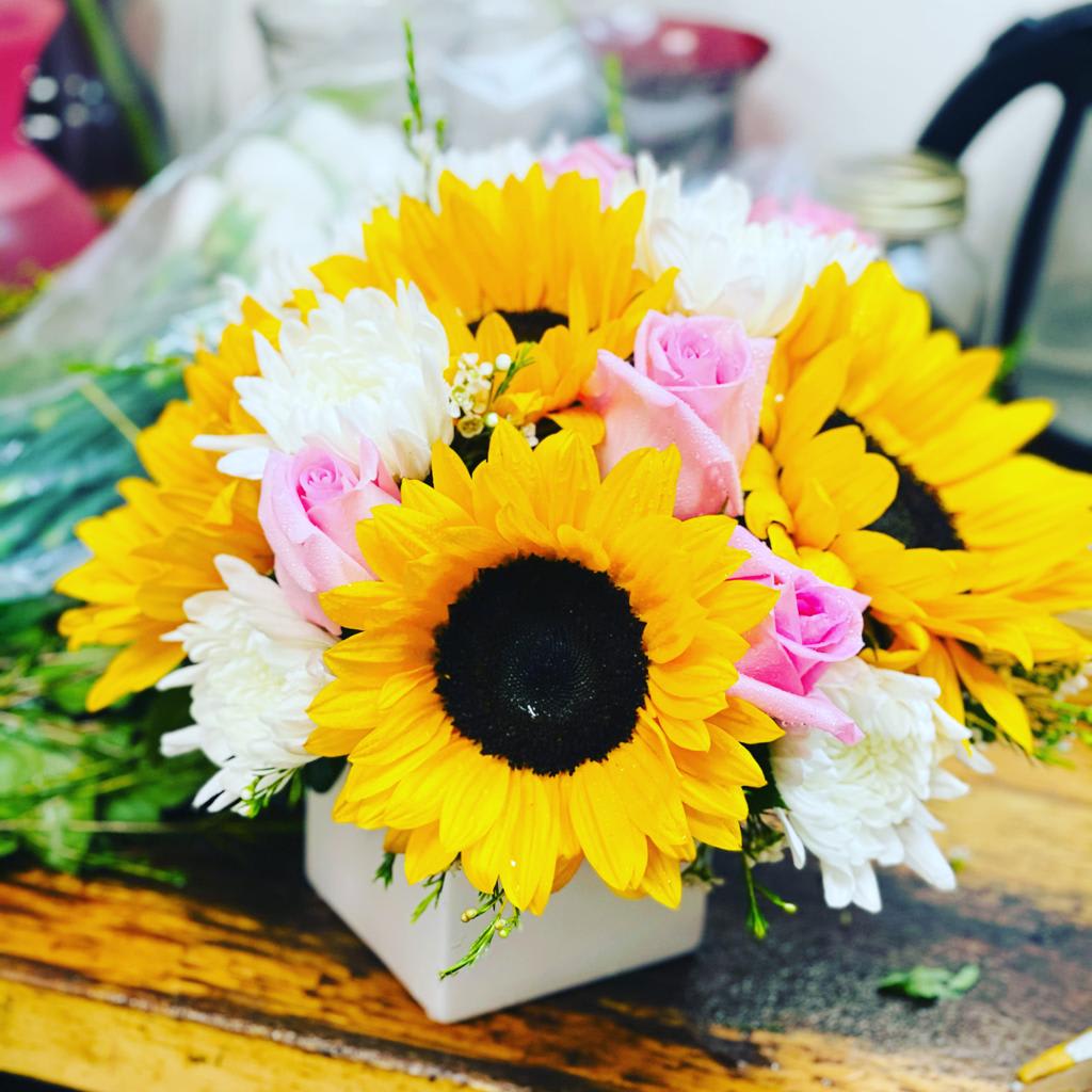 Feeling Groovy! - A simple mix of sunflowers, roses, and chrysanthemums is sure to impress. Bright yellow, pink and white tones will deliver a smile!