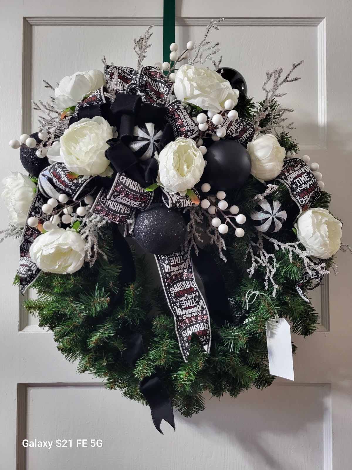 Wonderful Times Wreath - A fun grapevine wreath covered with black and white silk flowers, ornaments, a cute festive ribbon to welcome guests for the season!! 