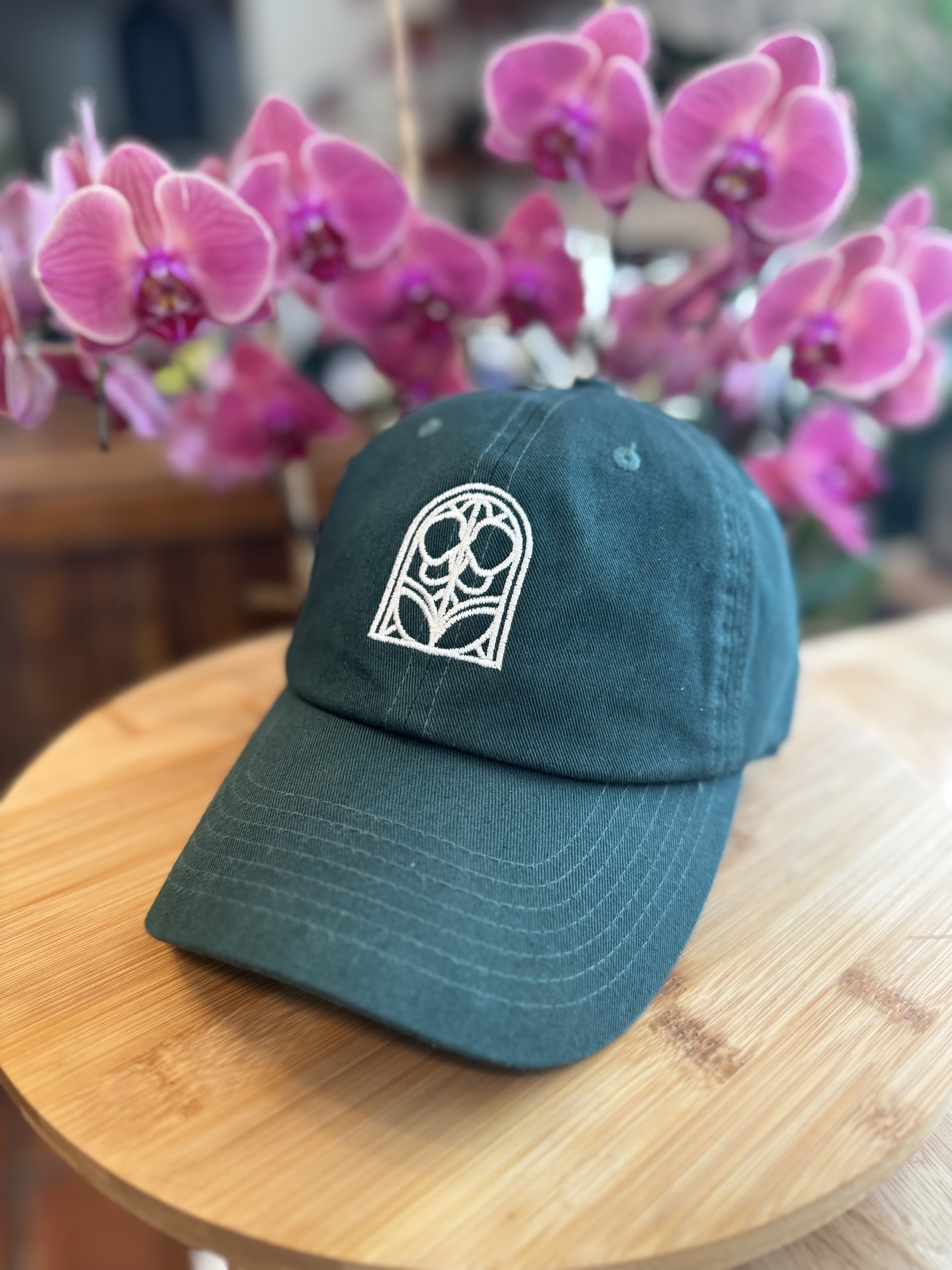Garden Gate Cap - Whether you’re out in the garden or on the go, this cap will keep you shaded and stylish, while showing your support four our business. Wear it , love it, and let the world know you’ve got a passion for orchids.