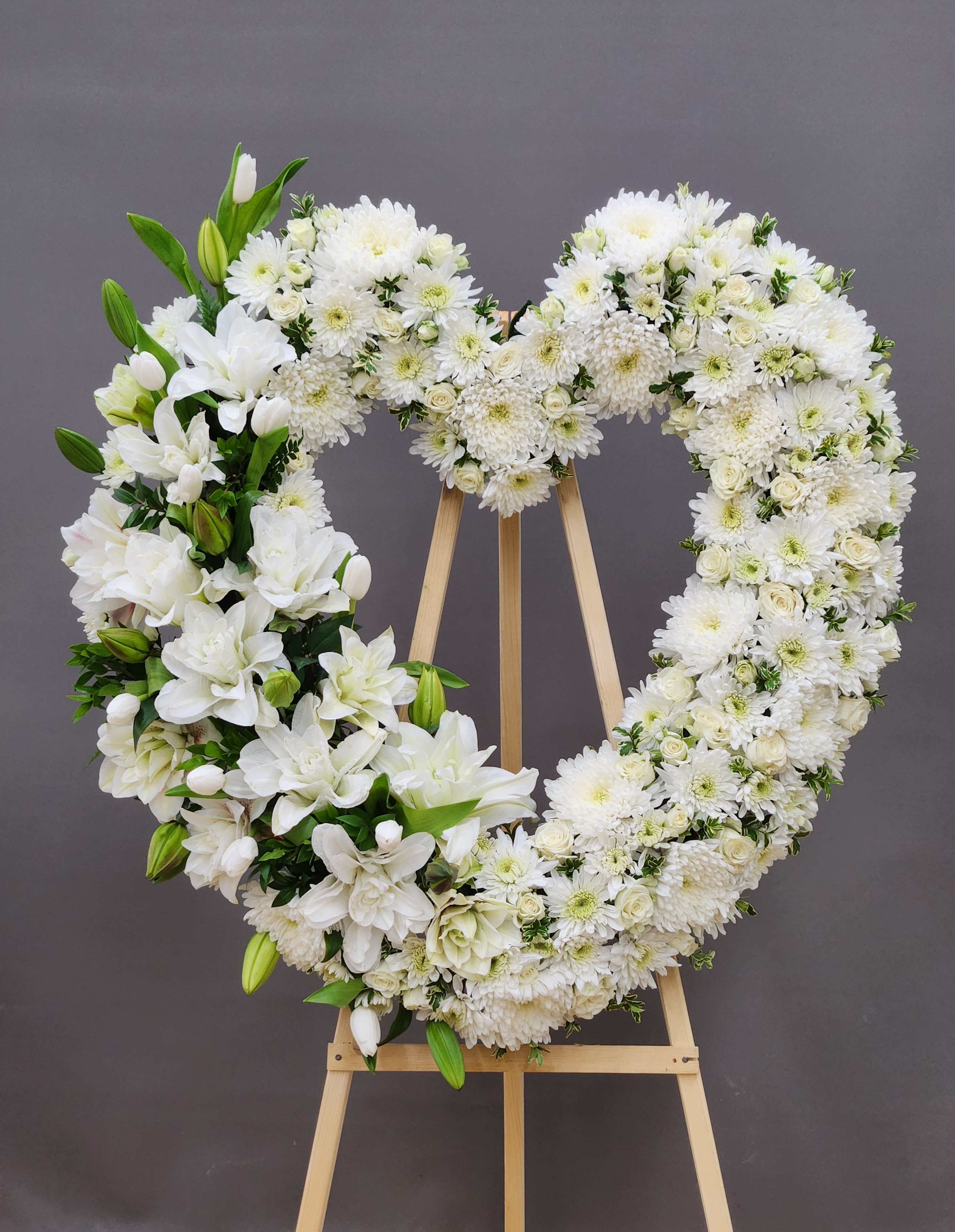 Pure Heart  - A timeless tribute of pristine white blooms arranged in a graceful heart shape, designed to honor and celebrate a life well-lived. This elegant arrangement conveys compassion, purity, and eternal love—perfect for memorial services and funeral occasions. Each flower is carefully selected for its quality and beauty, creating a luxurious presentation that speaks to the depth of your feelings during this meaningful moment.  AS PICTURED: PREMIUM 30&quot;