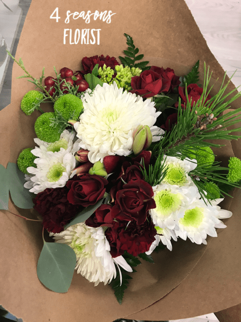 Holiday Bouquet - A seasonal selection of fresh flowers. Your bouquet may be accented with pinecones or other decorations. 