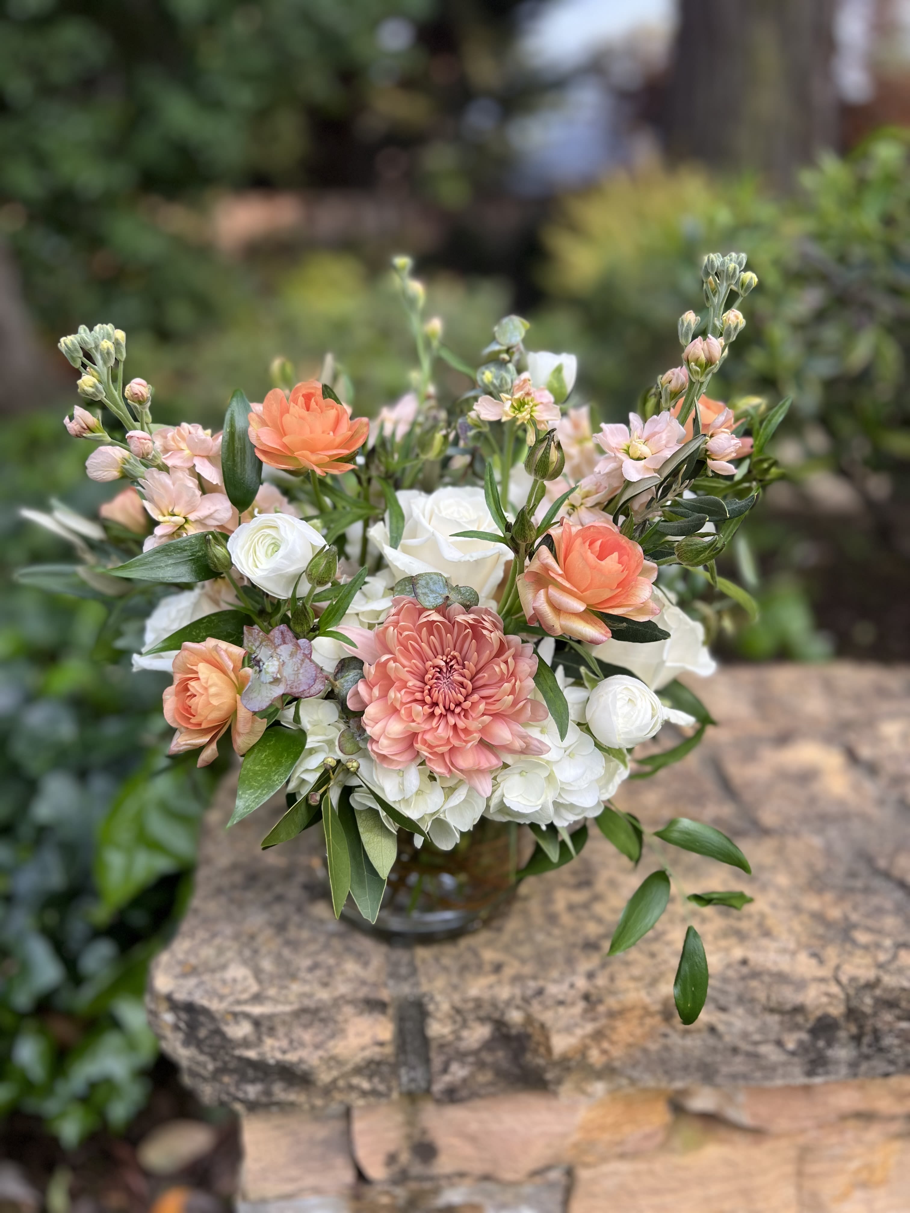 Peaches and Cream - Fluffy white hydrangeas, roses, and stock complimented with peach toned flowers like butterfly ranunculus and mums. 