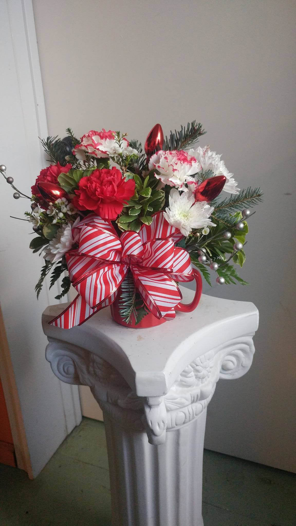 Candycane Christmas - Christmas arrangement in a holiday mug with a bow 