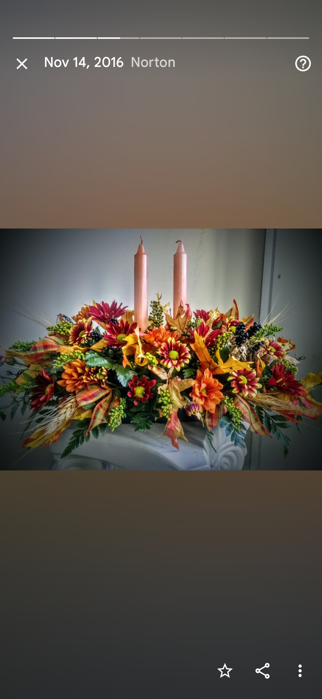Holiday centerpiece - A  low centerpiece consisting of the freshest holiday themed flowers, with ribbon,  and a candle.  (Upgrades add flowers, size and addl. Candle)  product may vary with availability.