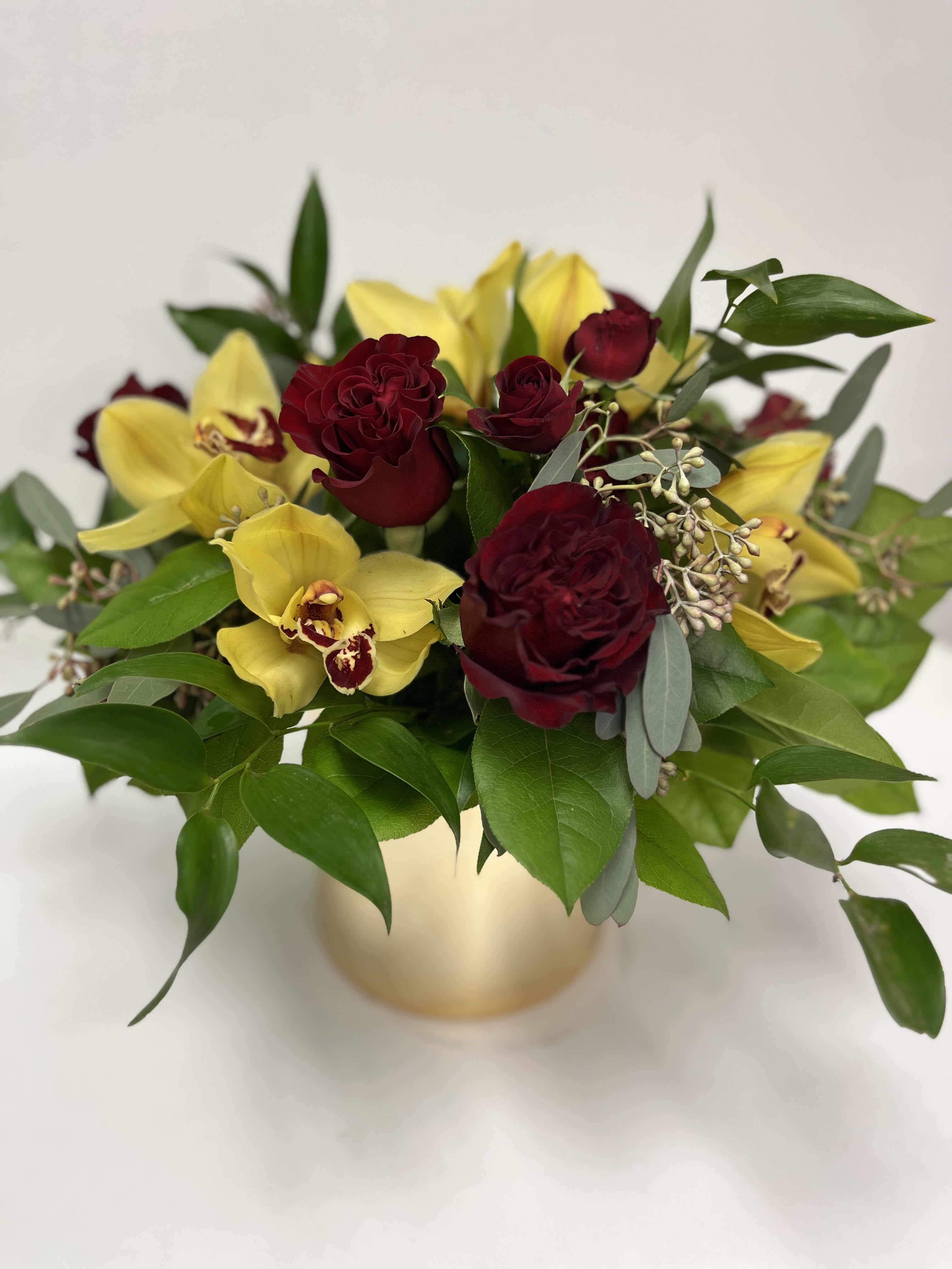 Golden Glamour - Elegant arrangement including roses, cymbids, eucalyptus and more.