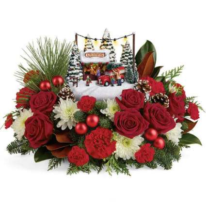 Thomas Kinkade 2017 Family Tree  - Set atop a magnificent bouquet of festive flowers and fresh Christmas greens, this light-up, hand-painted Thomas Kinkade collectible will brighten your holidays for years to come! This lush bouquet includes red roses, white mums, red miniature carnations, accented with flat cedar, and noble fir. Delivered with Teleflora's Thomas Kinkade's Snowfall Dreams keepsake. Orientation: All-Around