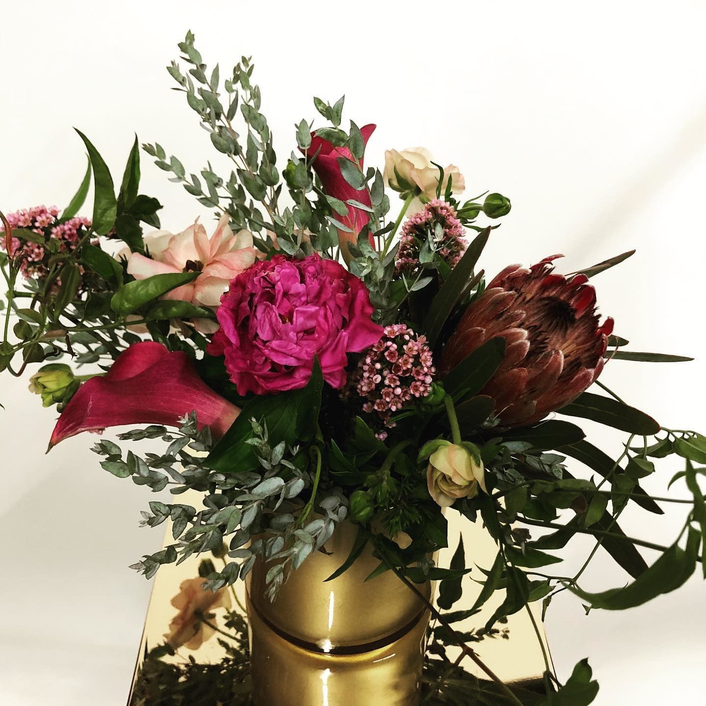 All Dressed Up - mix of hot pink and fuchsia florals in a gold cylinder vase