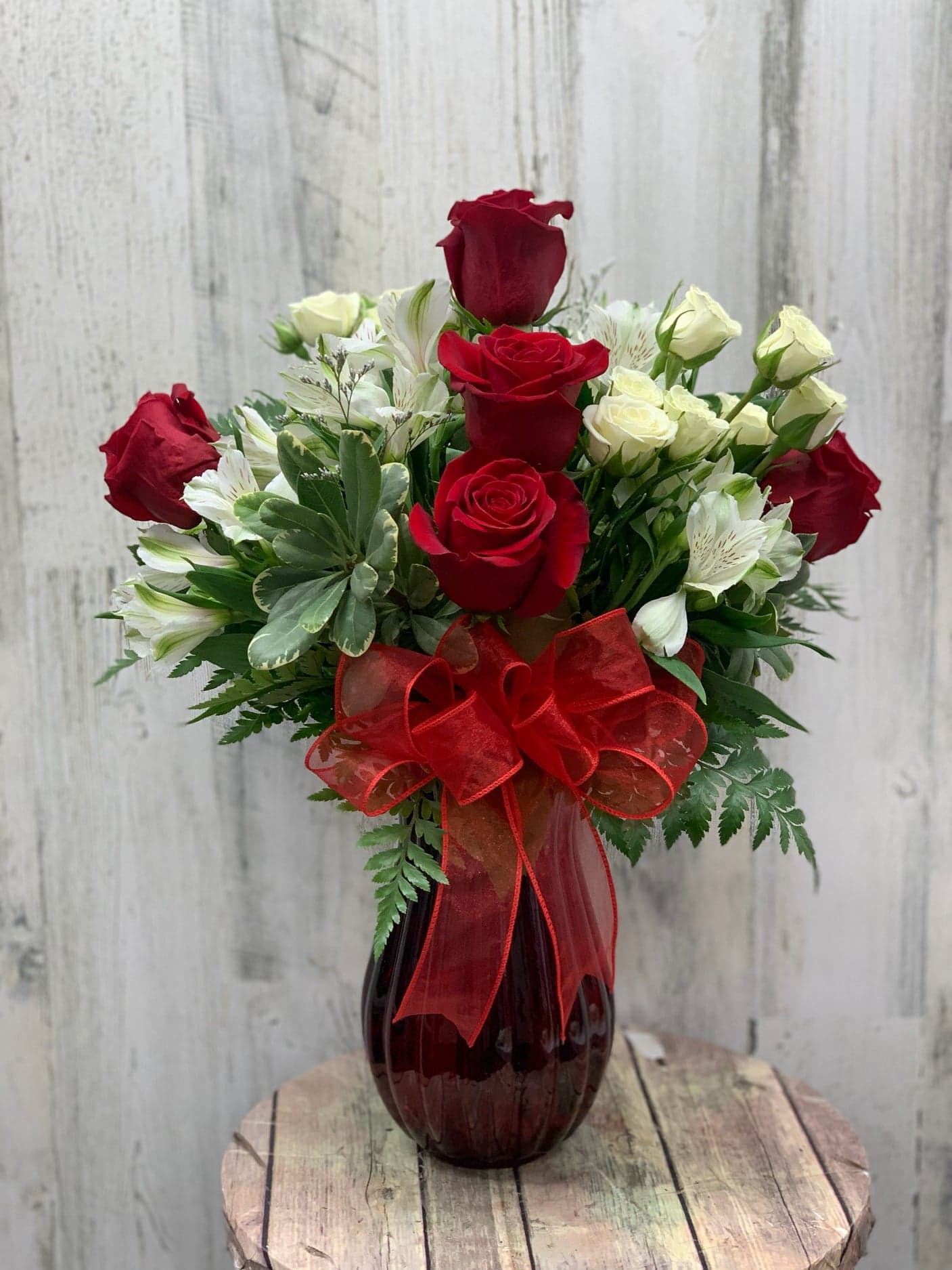 Angel Wings - Bright Red vase filled with fresh flowers anyone would be jealous of.