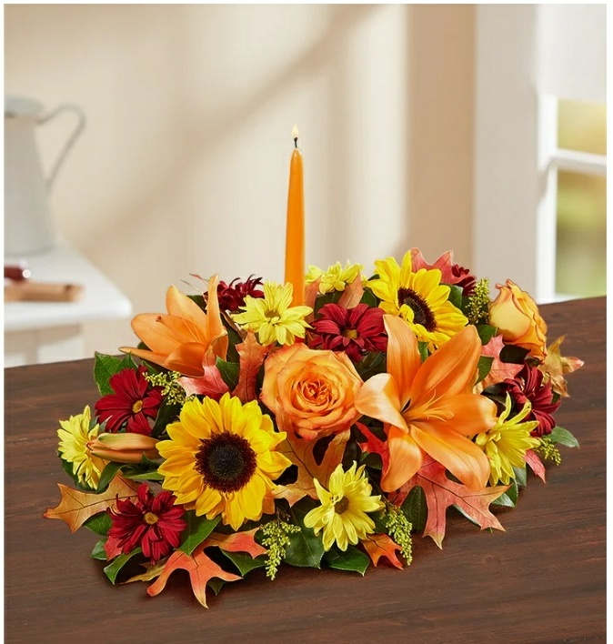 Orange  roses.candel.yellow and red flowers ,red or yellow Lily's.fall leaf and greens. - Great thanksgiving center piece