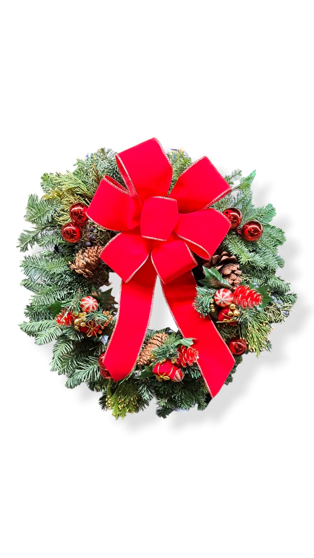 Santa’s Wreath - This beautiful wreath has a red theme. It has pinecones with ornaments and a big red bow. 