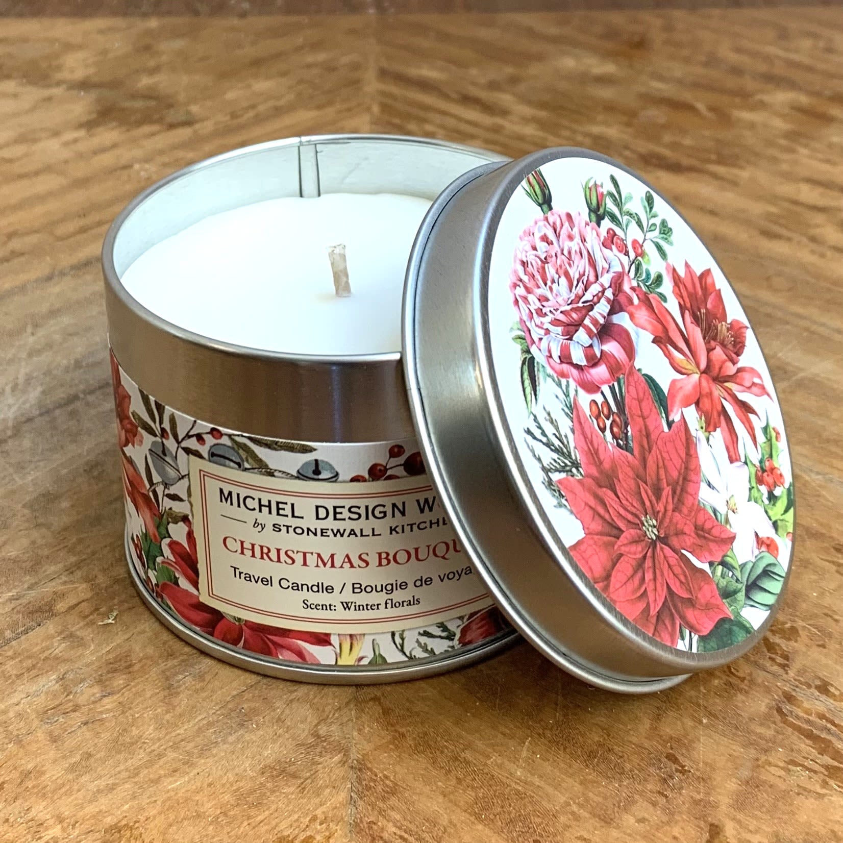 Christmas Bouquet Travel Candle - Our all-natural, travel candle is nontoxic, biodegradable and clean burning, made from a sustainably sourced soy and palm oil wax blend. The handy, decorative, and versatile tin can be used at home or when traveling, indoors or out. Scent: Winter florals with notes of red fruit, jasmine, and lavender A stunning design to welcome the holidays! Celebrate the season with this spectacular arrangement of winter florals and greenery. 5.5 oz / 155g 24 hours approximate burn time 