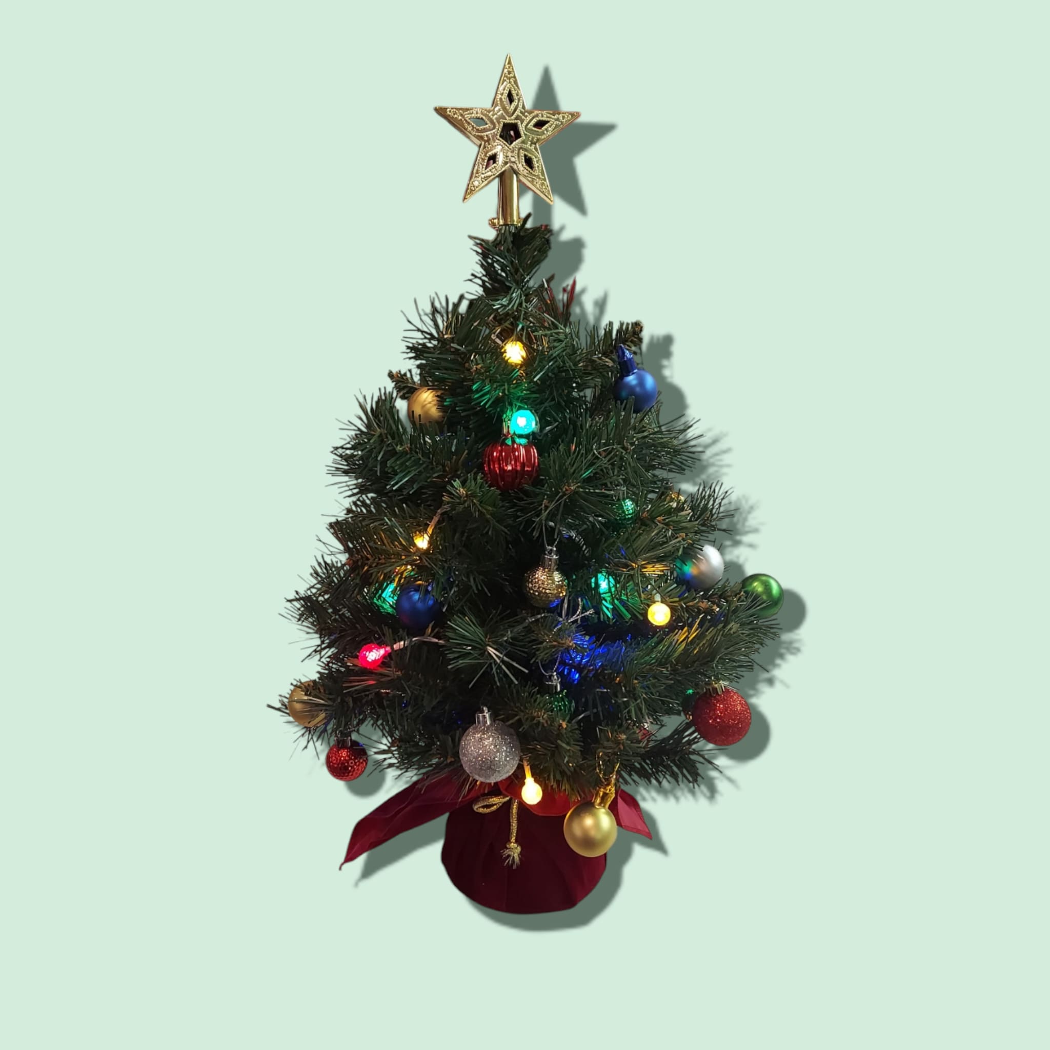 Tabletop Christmas Tree-*ARTIFICIAL  - Our artificial Tabletop Christmas Tree comes fully decorated with bulbs, a star topper, and battery powered timer lights. A perfect gift for someone who needs a little Christmas! Approximate size: 13&quot;H x 9&quot; W