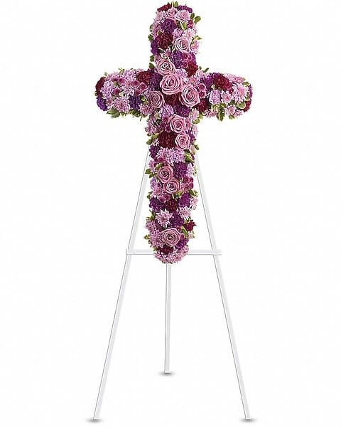 Deepest Faith Cross - Purple and lavender flowers thoughtfully arranged in the shape of a cross and displayed on a standing easel, offering a graceful expression of faith and remembrance.