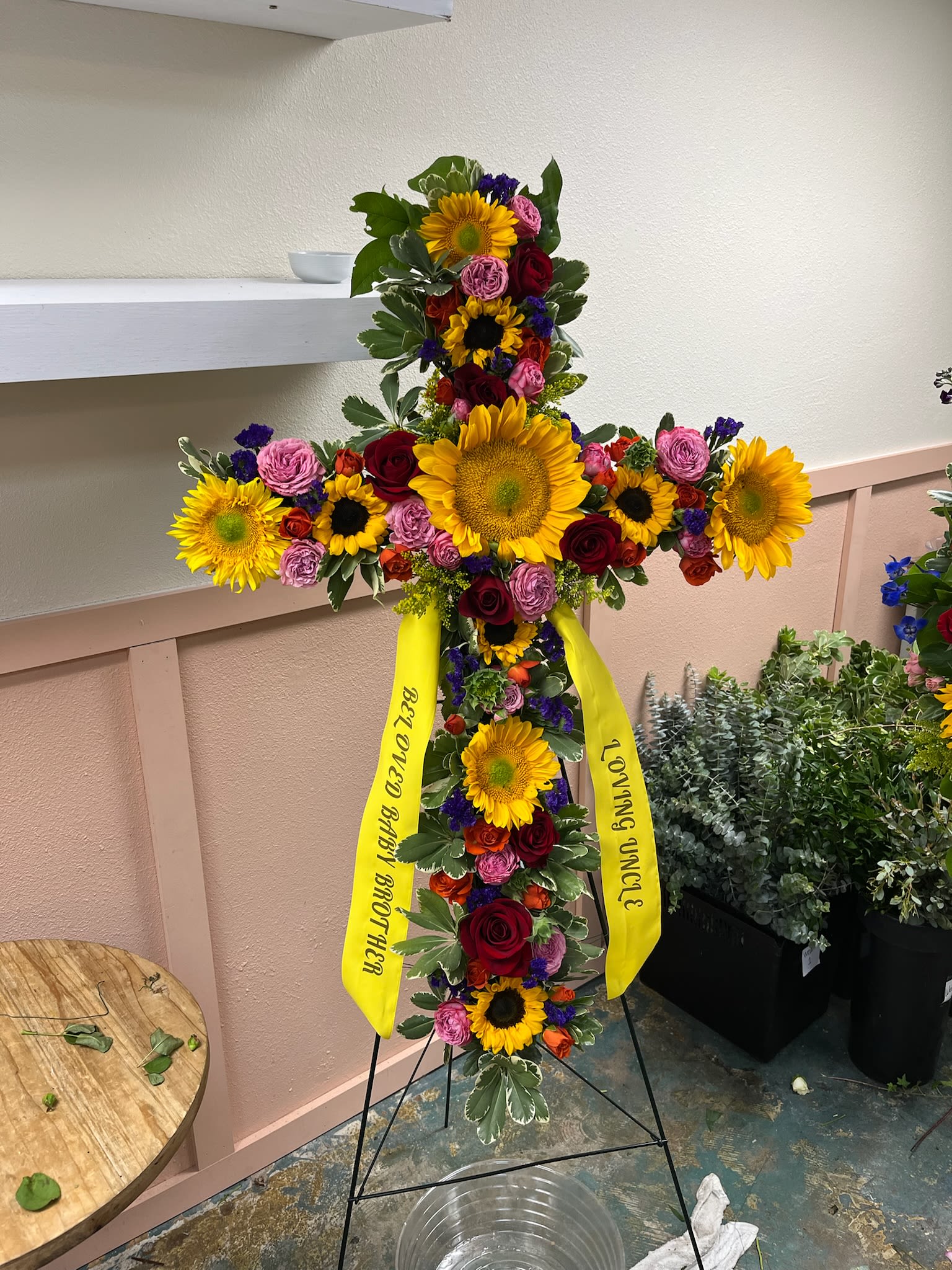 Floral Cross - A powerful symbol of faith, love, and remembrance, the Floral Cross Easel Display offers a heartfelt tribute to a loved one.