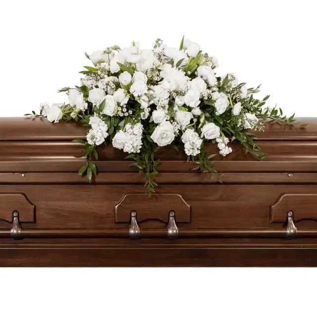 Eternal Peace Casket Spray - A casket spray composed entirely of white flowers and beautiful greenery serves as a striking tribute to the deceased, offering a sense of quiet strength and tranquility.