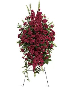 Deep in Our Hearts Spray - A striking and heartfelt expression of love and remembrance, this standing easel spray features an abundance of rich red roses paired with other deep red blooms