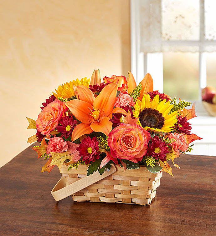 Sunny Basket - A beautiful Fall Basket of Sunflowers, Orange Lilies. orange roses and seasonal accents in a natural color basket.