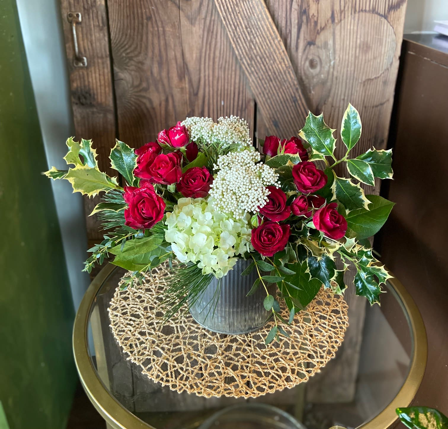 Sending Holiday Love - Delicate spray roses with hydrangeas and festive filler.  Adorned with evergreens in trendy metal container.