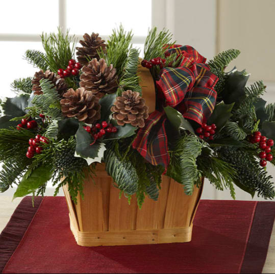 Christmas Coziness  - Adding warmth and a homespun look to your Christmas decor, this fresh and fragrant floral arrangement is a wonderful way to bring color and life to any corner of the home. An assortment of Christmas greens and variegated holly are arranged to perfection in a rectangular stained woodchip basket, accented with clusters of red berries, natural pinecones, and a festive red plaid ribbon. A wonderful holiday gift for your relatives, neighbors, or friends throughout the yuletide season ahead. GOOD bouquet includes 4 stems. Approx. 10&quot;H x 15&quot;W. BETTER bouquet includes 6 stems. Approx. 10&quot;H x 17&quot;W.