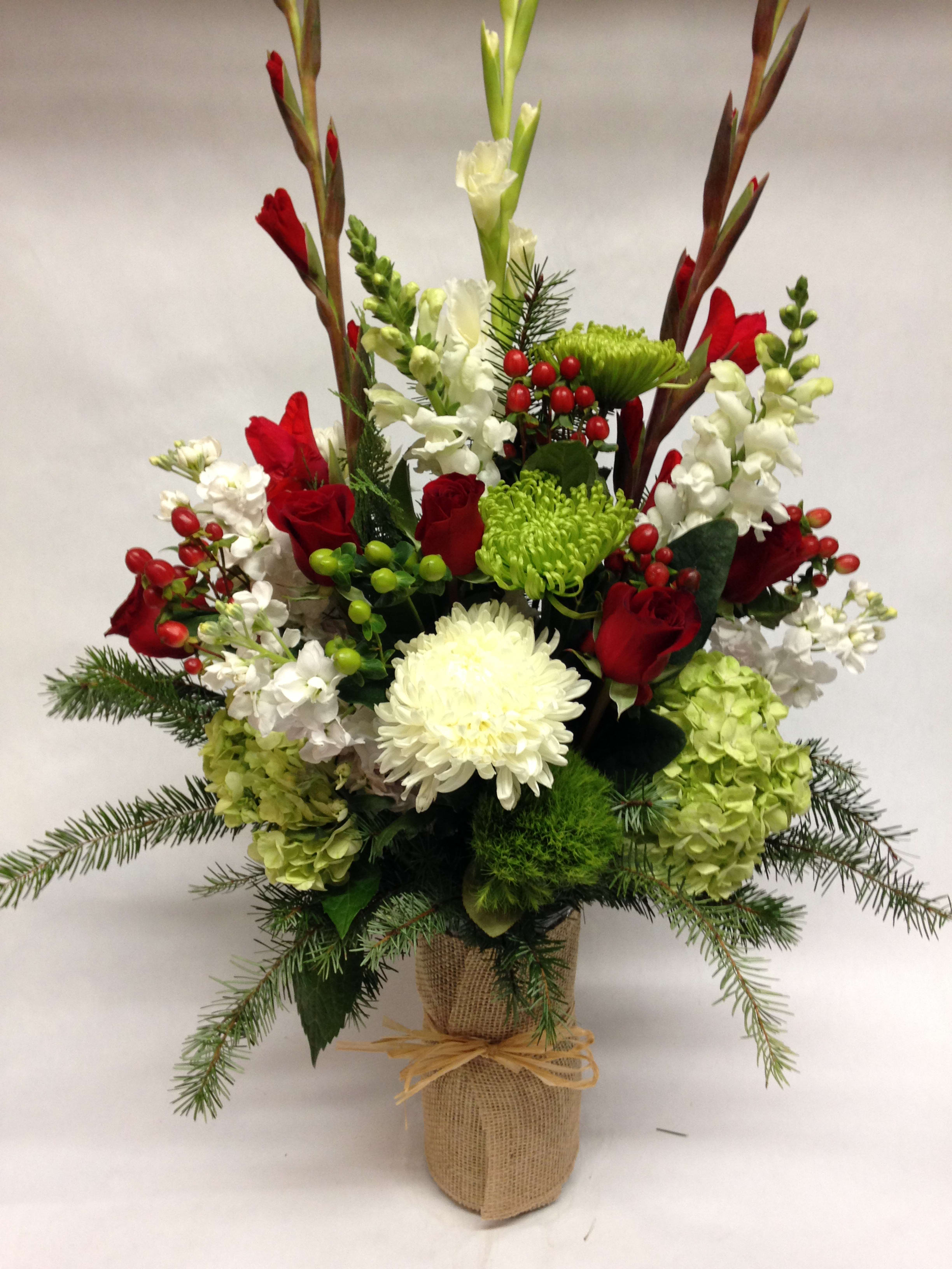 Festivus - This winter inspired arrangement comes complete with spider mums, snapdragons, dianthus, gladiolas, roses, hypericum, stock, hydrangea  and various winter greenery.  (Some flowers may be subject to change depending on the season. We will contact you with available flower substitutions; please contact us with specific questions if you are concerned with flower availability, thanks!) Featured arrangement: $285 (REGULAR PRICE)