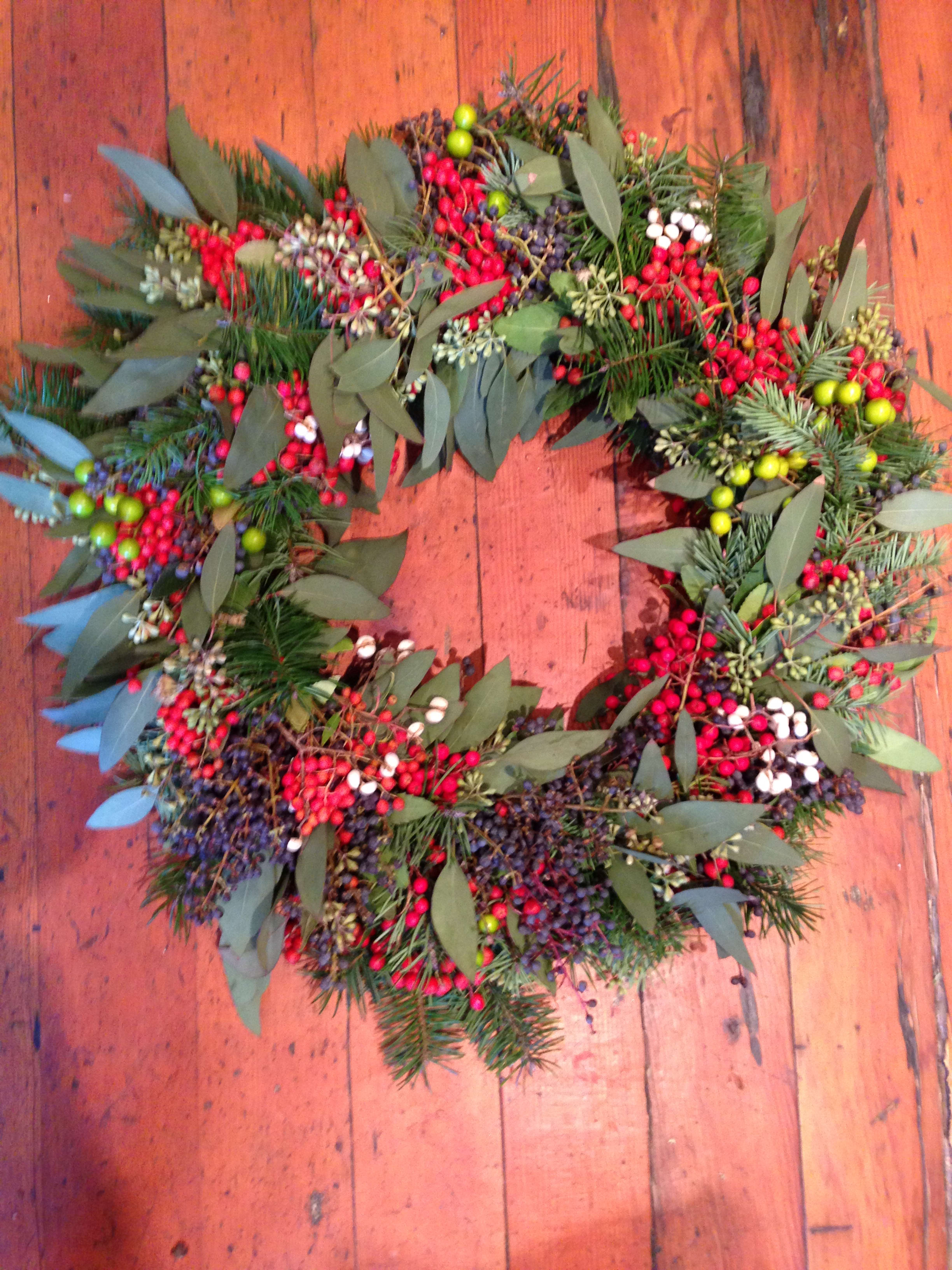 Festive Winter Wreath - Add some cheer to you or your loved one's entryway! This pine and eucalyptus wreath is complimented by bright berries. Featured wreath: $155.00