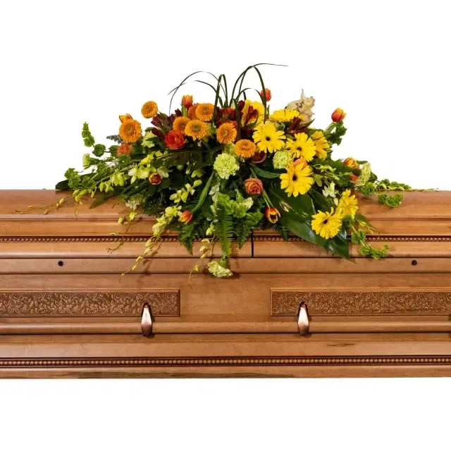 Tropical Tranquility Casket Spray - Elegant and vibrant, this tropical-inspired spray illuminates cherished memories that will be eternally valued. Bursting with color and anchored by earthy tones, it offers solace any memorial service.